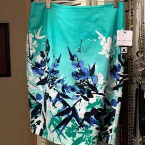 Spring skirt fully lined. Length 23-1/2” and width at waist 16” across.